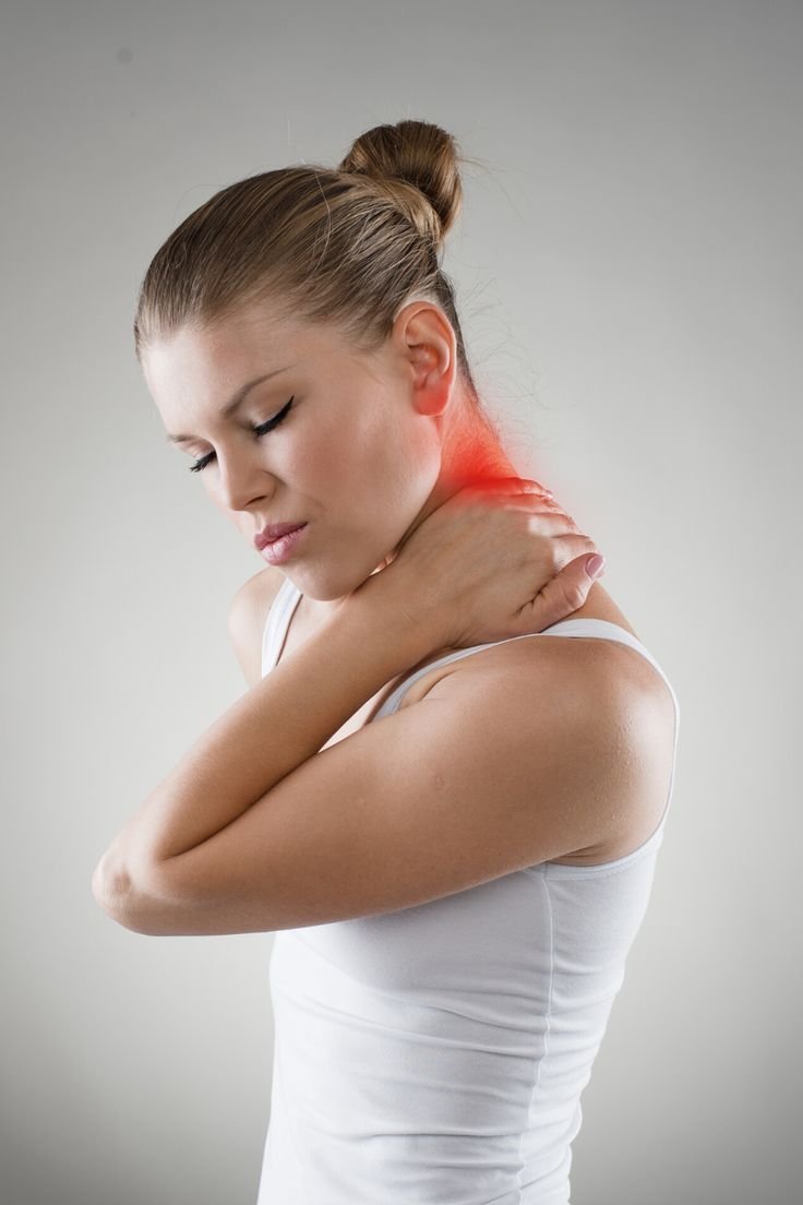 Person lying face down receiving acupuncture for neck pain